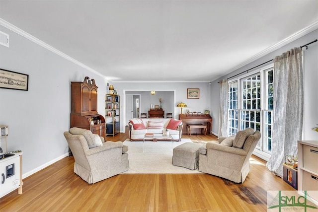 living area featuring a wealth of natural light, crown molding, and wood finished floors