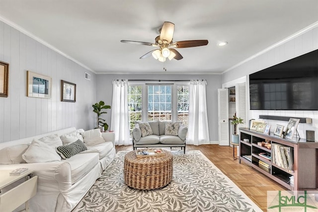 living area featuring visible vents, crown molding, and ceiling fan