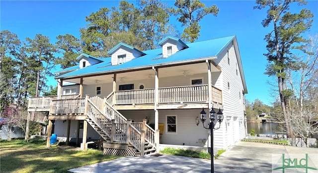 view of front of house with stairway, a front lawn, and ceiling fan