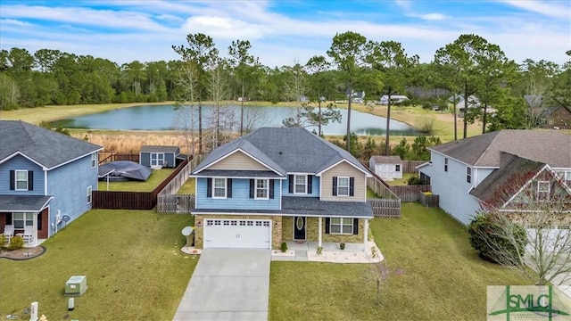 view of front facade with a water view, concrete driveway, an attached garage, and fence