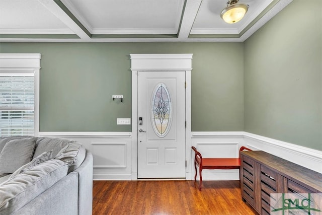 foyer with crown molding, wood finished floors, and a wainscoted wall