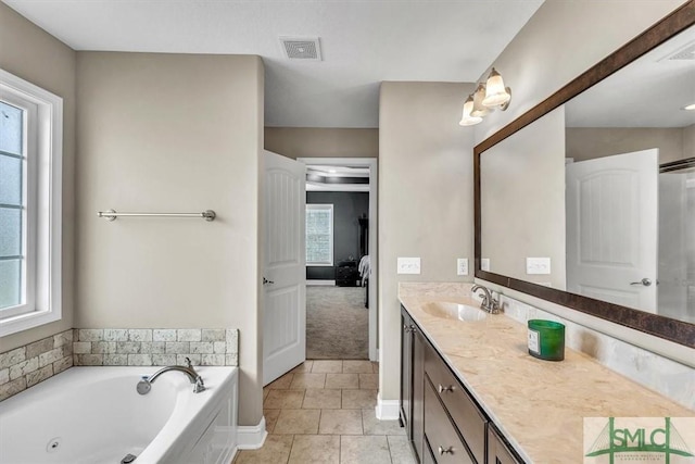 full bathroom with a healthy amount of sunlight, visible vents, and ensuite bathroom