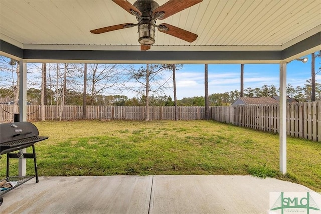 view of yard featuring a fenced backyard, a ceiling fan, and a patio area