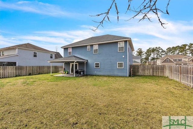 rear view of house with a fenced backyard, a patio, and a yard