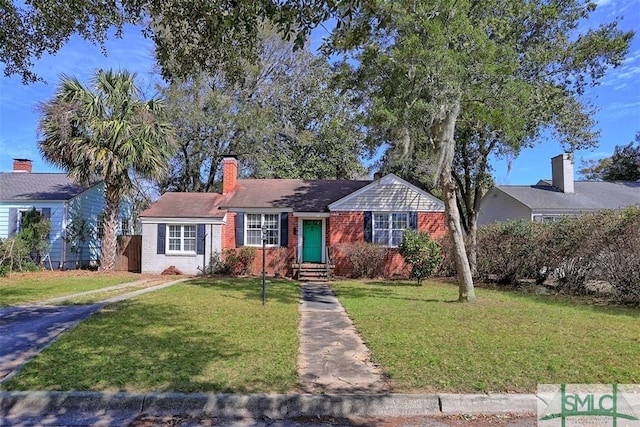 single story home with a front lawn, fence, brick siding, and a chimney