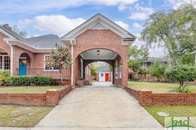 view of community with a lawn and driveway