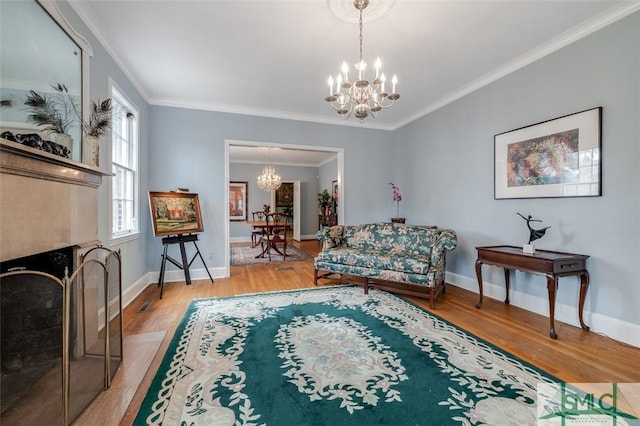 living room featuring a notable chandelier, wood finished floors, a tiled fireplace, and ornamental molding