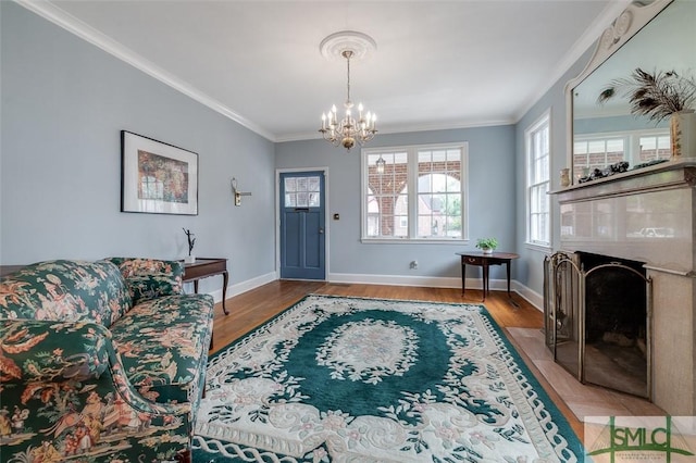 living area with crown molding, baseboards, and wood finished floors