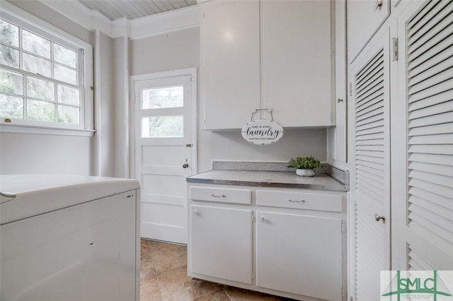 laundry area featuring washer / clothes dryer and ornamental molding