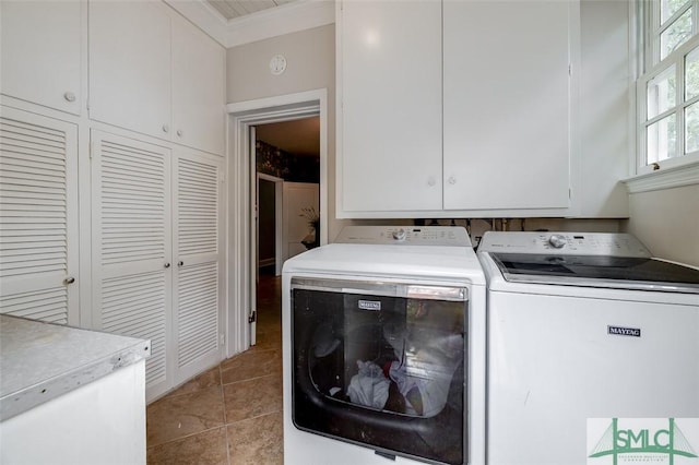 washroom featuring light tile patterned flooring, cabinet space, ornamental molding, and separate washer and dryer