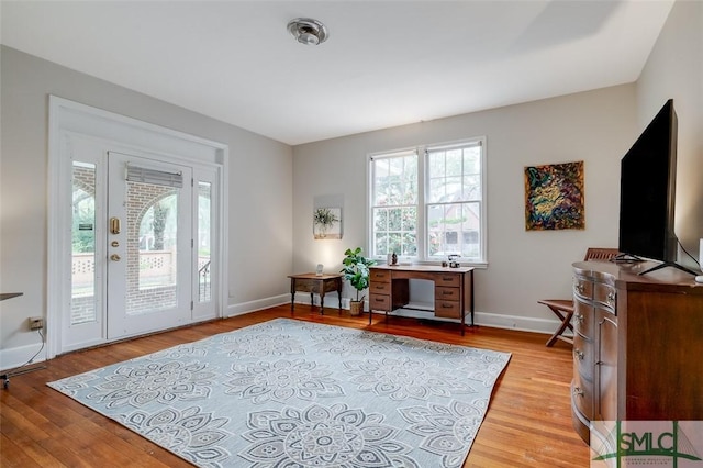 foyer featuring baseboards and light wood-style floors