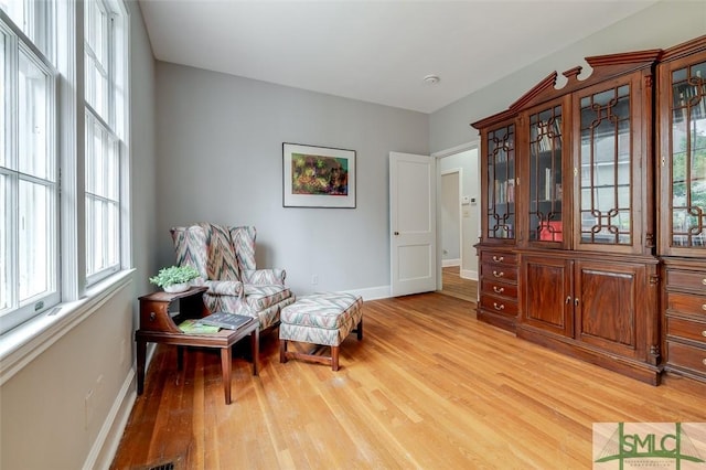 living area featuring light wood-type flooring and baseboards