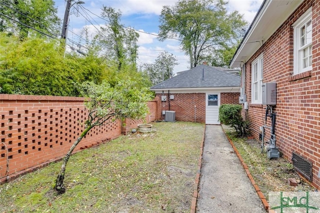 view of yard with cooling unit and fence