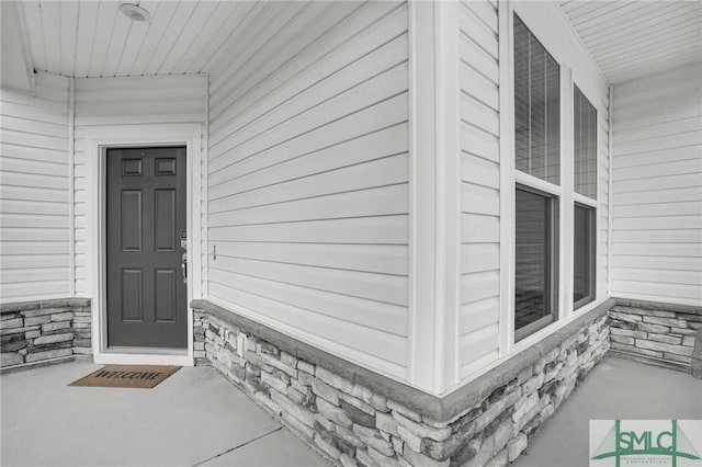 view of exterior entry featuring stone siding