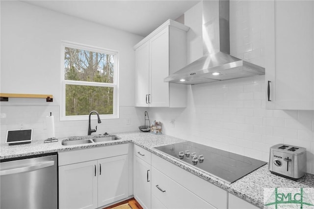 kitchen with a sink, decorative backsplash, stainless steel dishwasher, black electric stovetop, and wall chimney exhaust hood