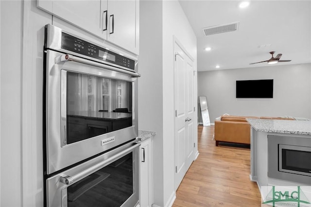 kitchen with visible vents, open floor plan, light wood-type flooring, recessed lighting, and appliances with stainless steel finishes