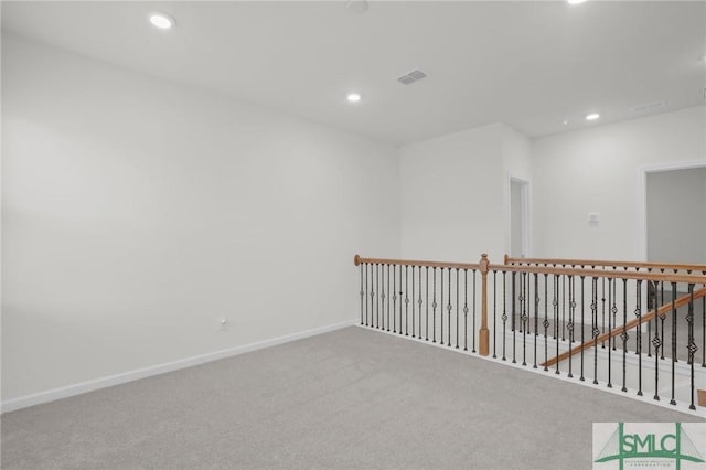 carpeted empty room featuring visible vents, recessed lighting, and baseboards