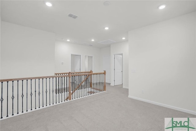 carpeted empty room with visible vents, recessed lighting, and baseboards