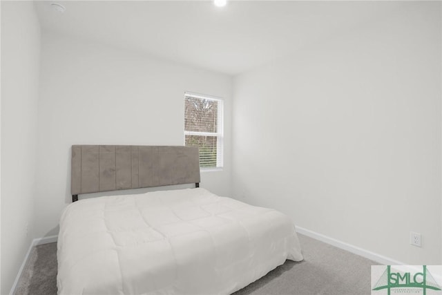 bedroom with baseboards and carpet floors