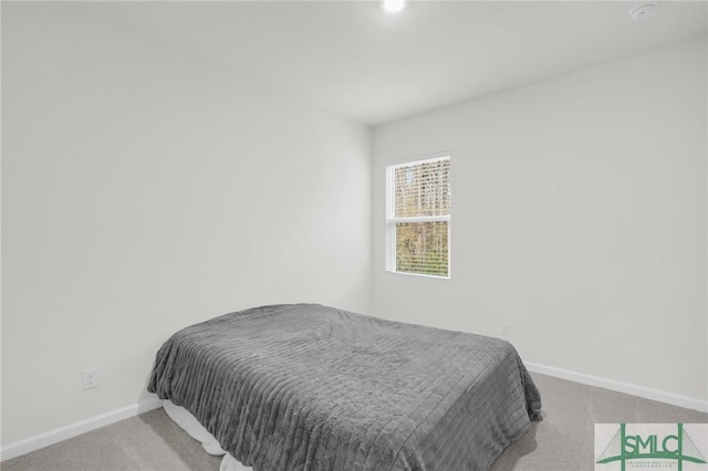 carpeted bedroom featuring baseboards