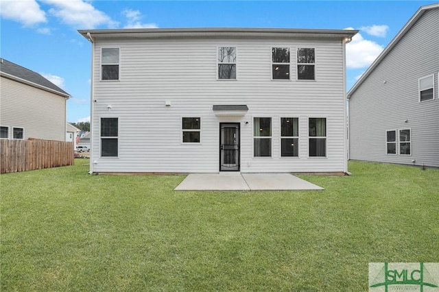 back of property featuring a yard, a patio, and fence