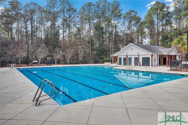 community pool featuring a patio area and fence