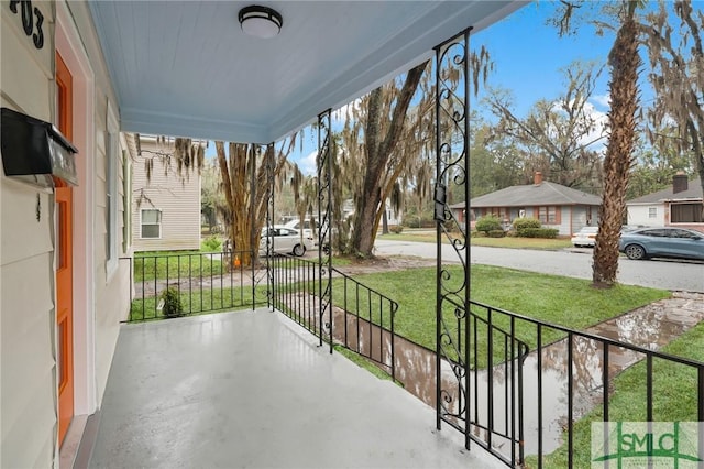 balcony with a residential view and a porch