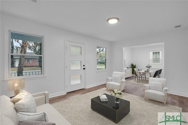 living area featuring baseboards and wood finished floors