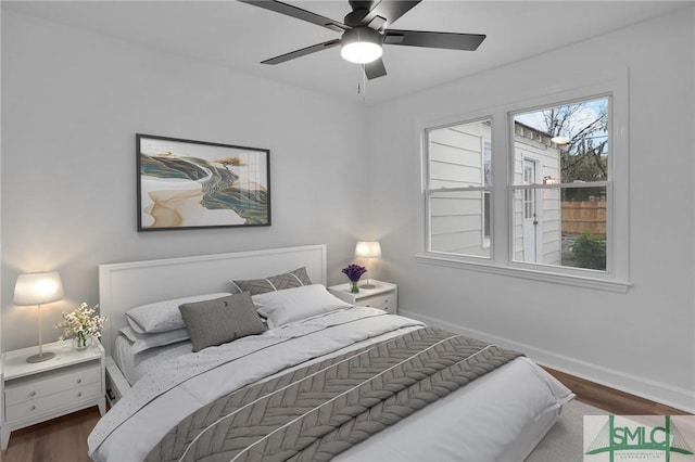 bedroom featuring a ceiling fan, wood finished floors, and baseboards