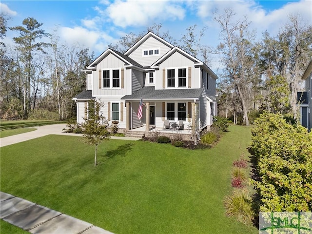 view of front of home featuring a porch, board and batten siding, driveway, and a front lawn