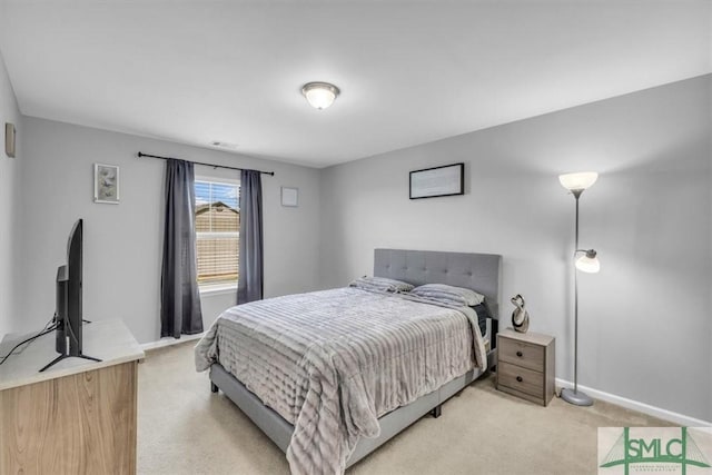 bedroom featuring light colored carpet and baseboards