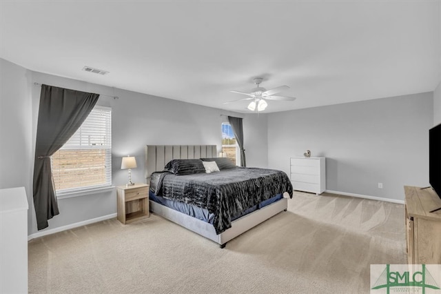 carpeted bedroom with visible vents, ceiling fan, and baseboards