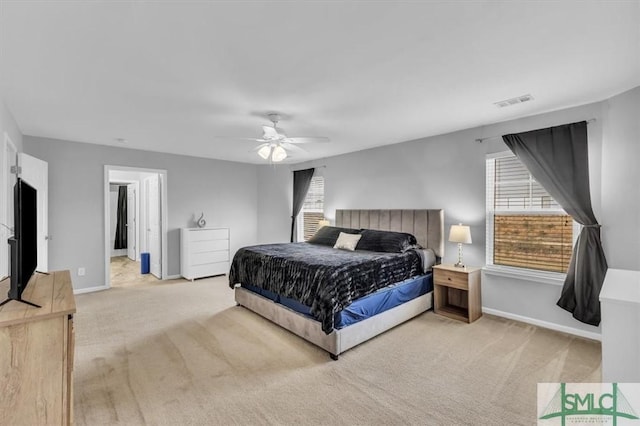 carpeted bedroom featuring visible vents, a ceiling fan, and baseboards