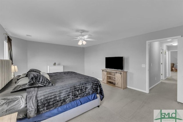 carpeted bedroom with a ceiling fan and baseboards