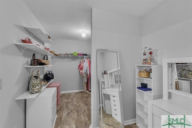 spacious closet with wood finished floors