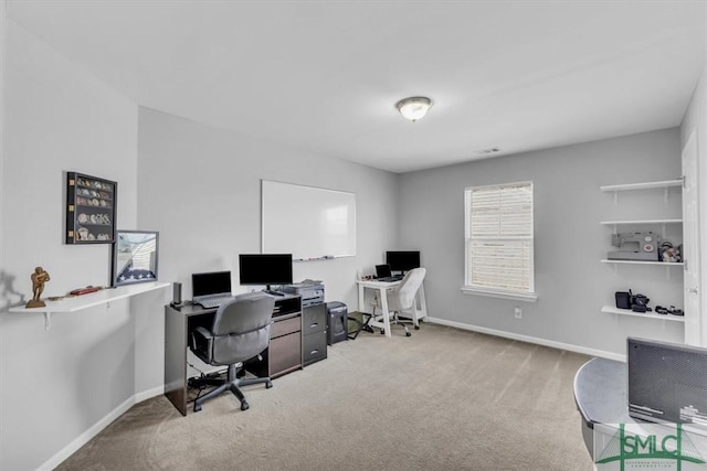 carpeted office featuring baseboards