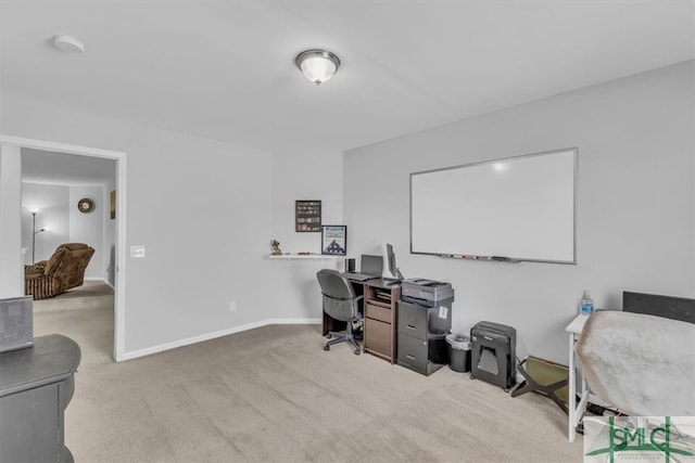 carpeted office space featuring baseboards