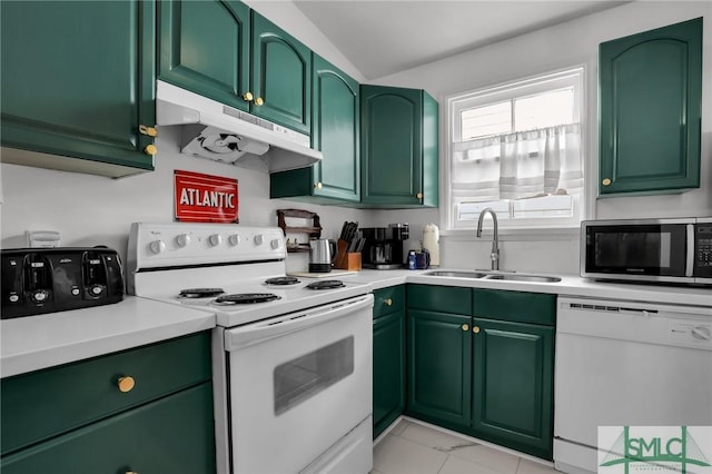 kitchen featuring under cabinet range hood, green cabinetry, light countertops, white appliances, and a sink