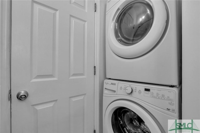 clothes washing area featuring laundry area and stacked washer / dryer