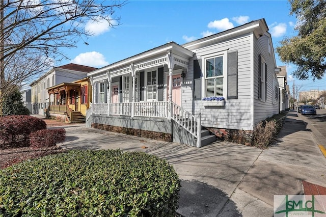 view of front of house with covered porch and concrete driveway