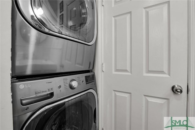 washroom featuring laundry area and stacked washing maching and dryer