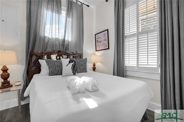 bedroom featuring wood finished floors and baseboards