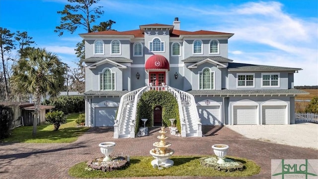 view of front of house featuring french doors, a garage, and driveway