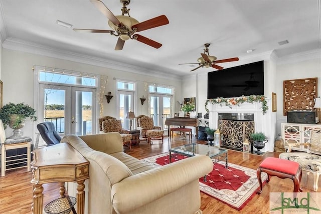 living room with ceiling fan, french doors, and wood finished floors