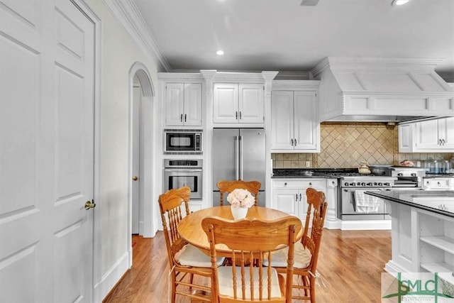 kitchen featuring light wood-style floors, custom exhaust hood, white cabinetry, high end appliances, and open shelves