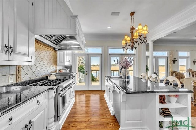kitchen featuring white cabinets, appliances with stainless steel finishes, a sink, french doors, and light wood-type flooring
