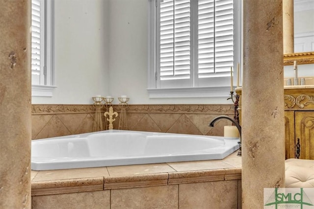 full bath with plenty of natural light and a bath