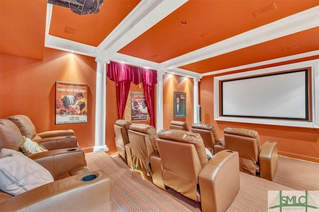 carpeted home theater featuring crown molding, ornate columns, and baseboards