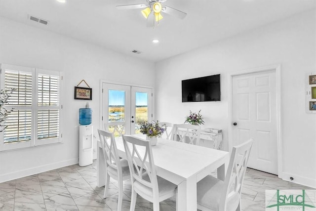 dining space with a ceiling fan, baseboards, visible vents, and marble finish floor