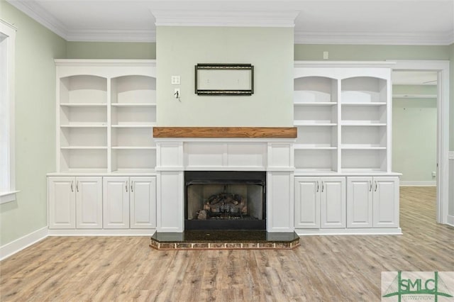 unfurnished living room with light wood-style flooring, baseboards, and ornamental molding